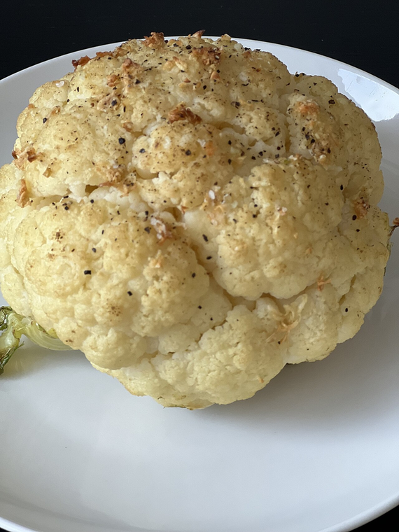 Cauliflower Tips HH — whole roasted cauliflower, charred and seasoned, on a white plate