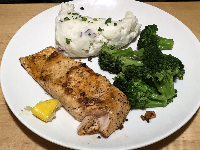 Glazed Salmon — glazed salmon fillet with mash and broccoli on a white plate