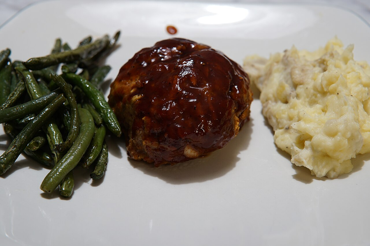 The Southern Rx — glazed grass-fed meatloaf with green beans and potatoes on a white plate